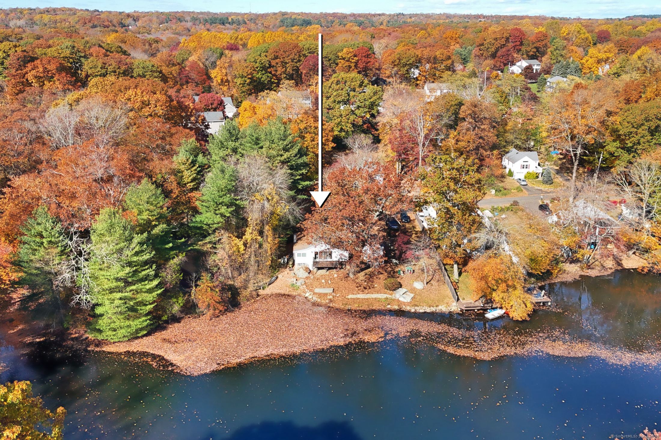 an aerial view of residential houses with outdoor space and lake view