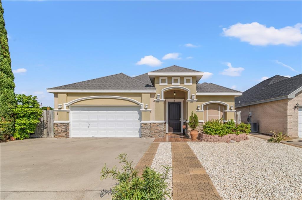 a front view of a house with a yard and garage