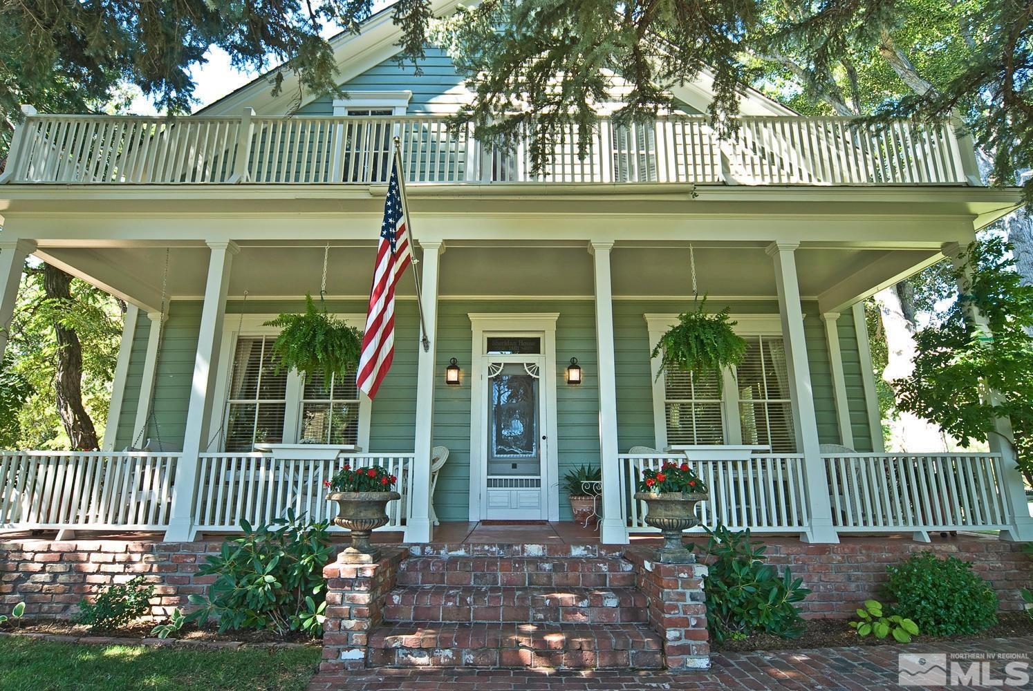 front view of a brick house with a small yard