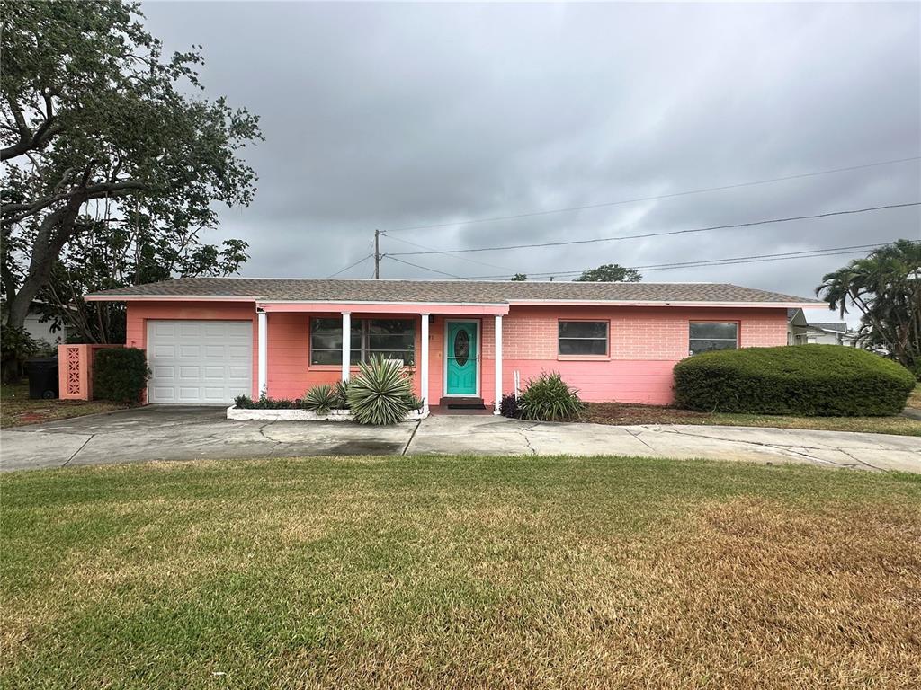 a front view of house with yard and trees