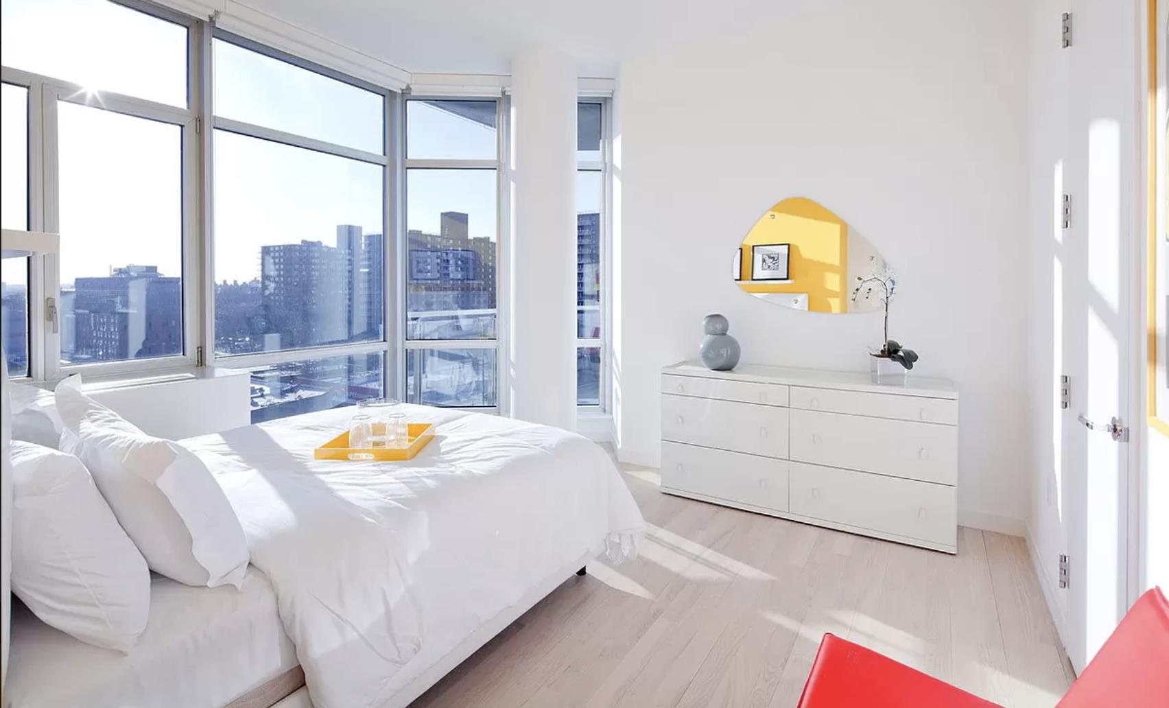 a bedroom with a bed and a view of walk in closet