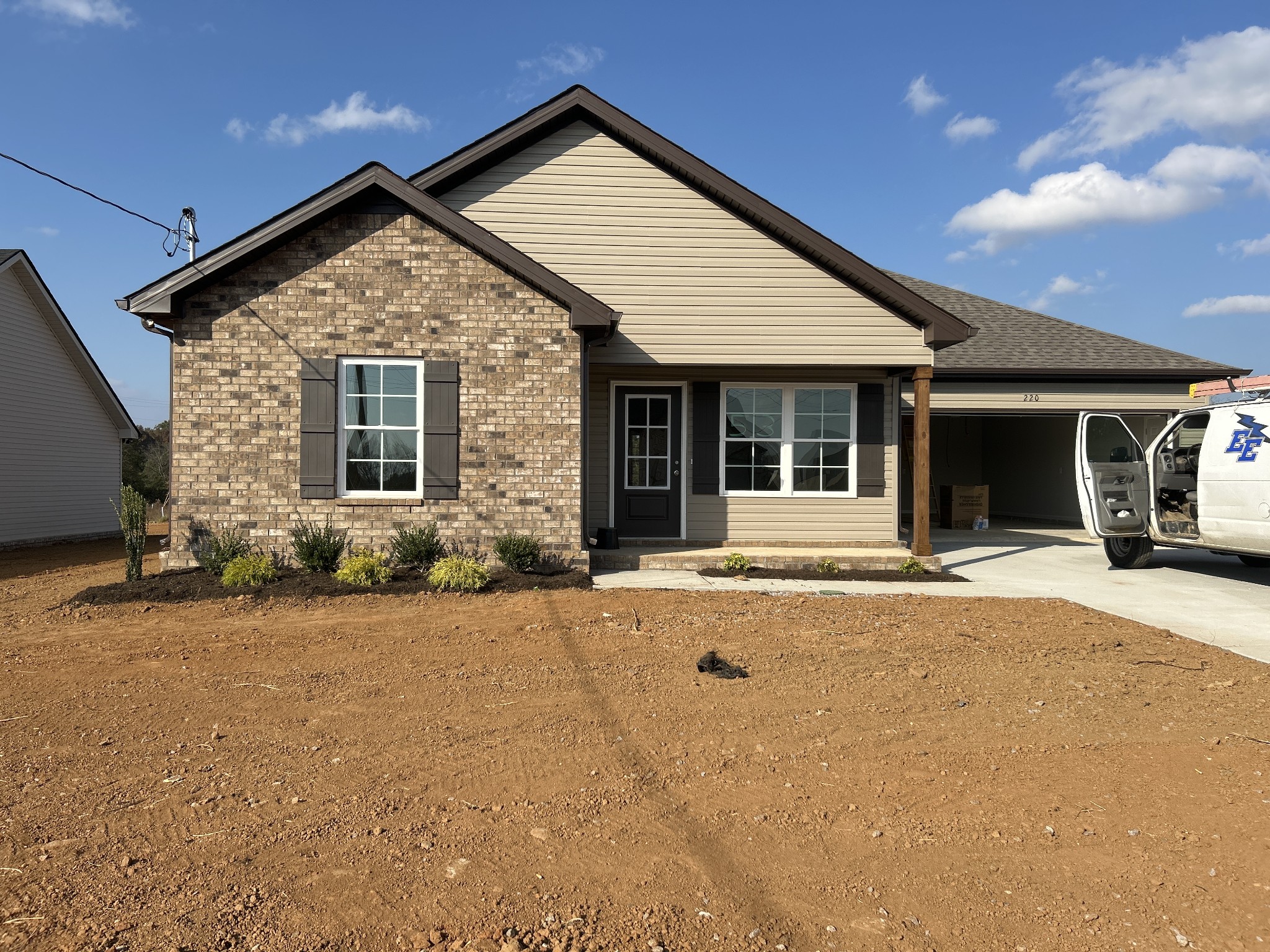 a view of a house with backyard and porch