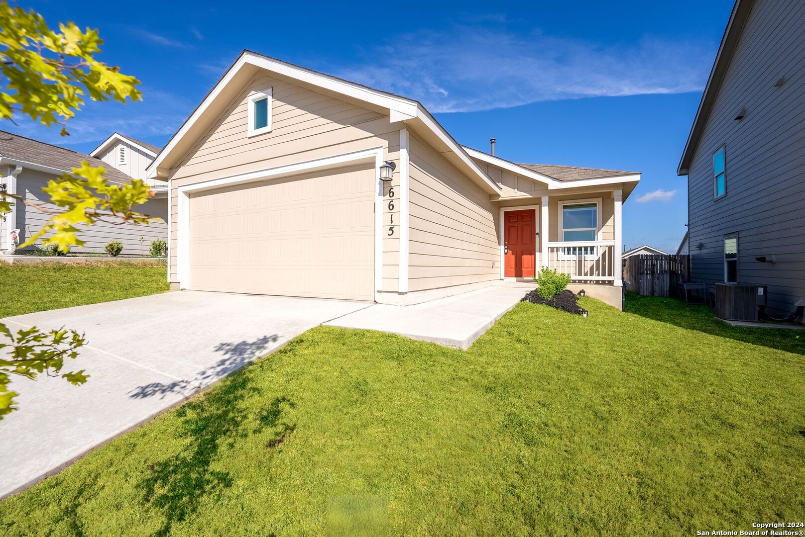 a front view of a house with a garden and yard