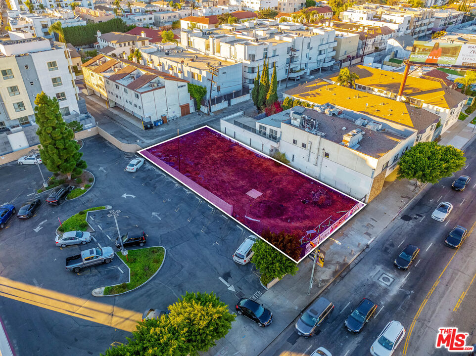 an aerial view of a pool with a yard