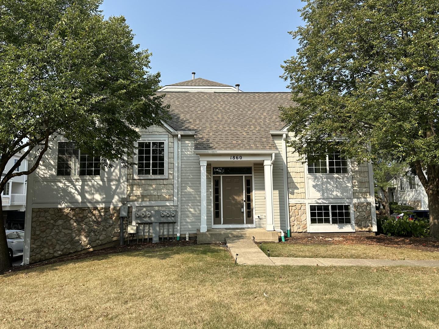 a front view of a house with a yard