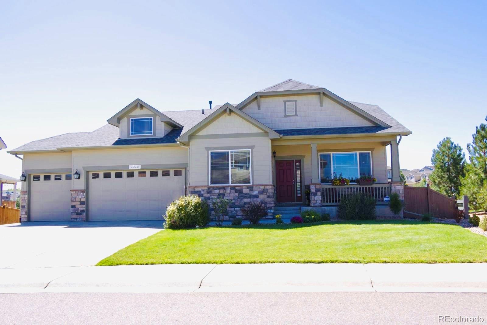 a front view of a house with a garden and yard