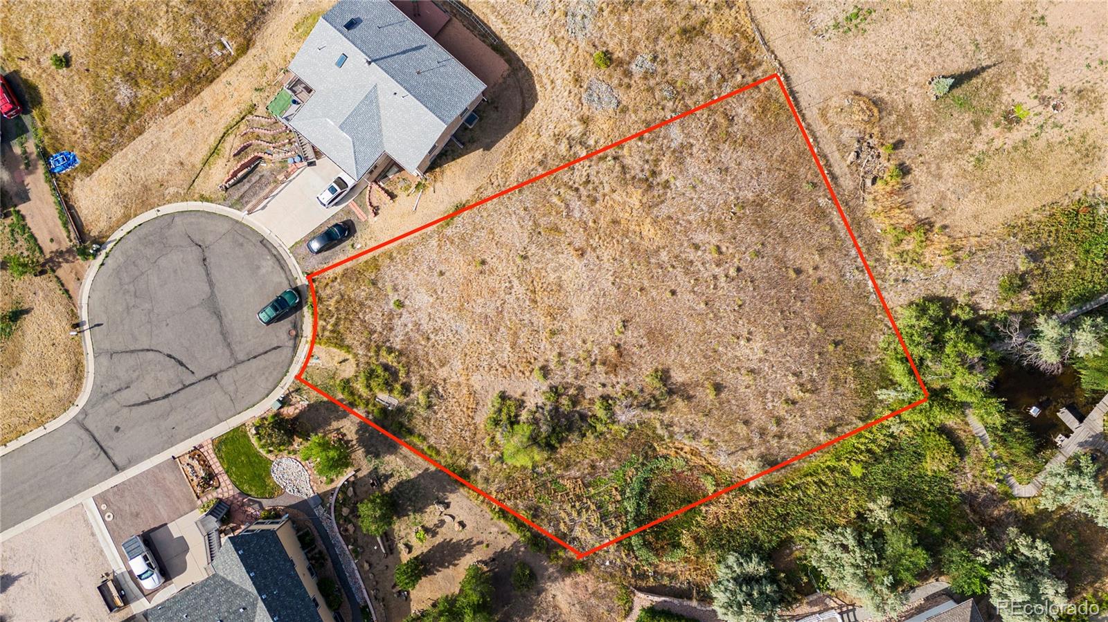 an aerial view of a house with a yard