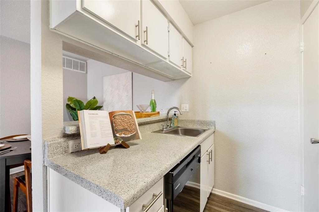 a kitchen with a sink a counter and cabinets