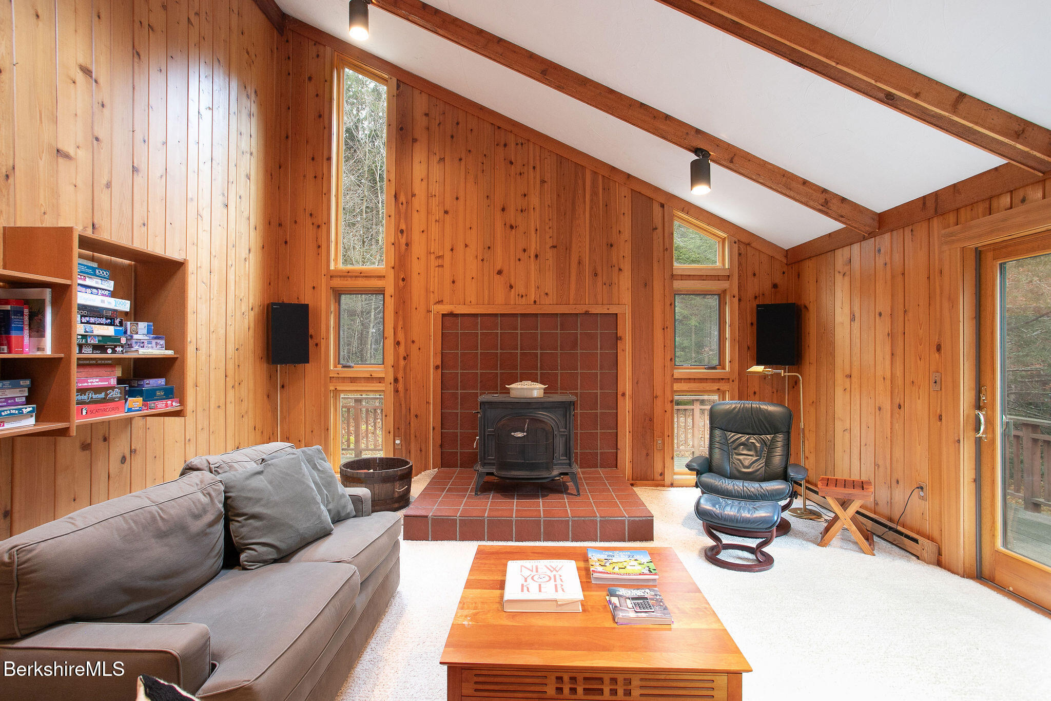 a living room with furniture a rug and a fireplace