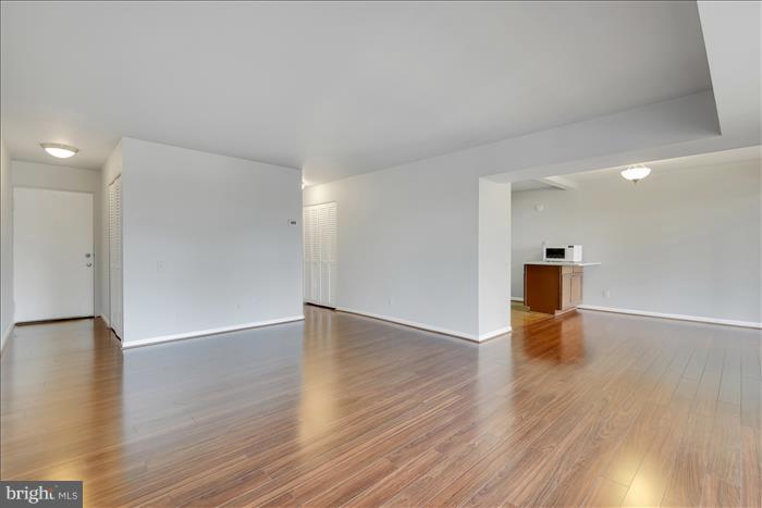 a view of empty room with wooden floor