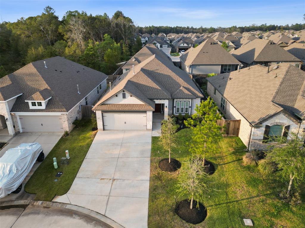 an aerial view of a house with yard