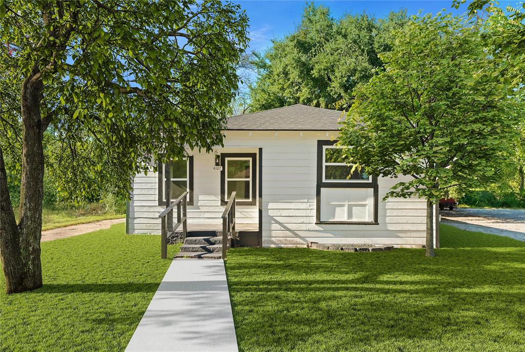 a front view of a house with a garden and yard