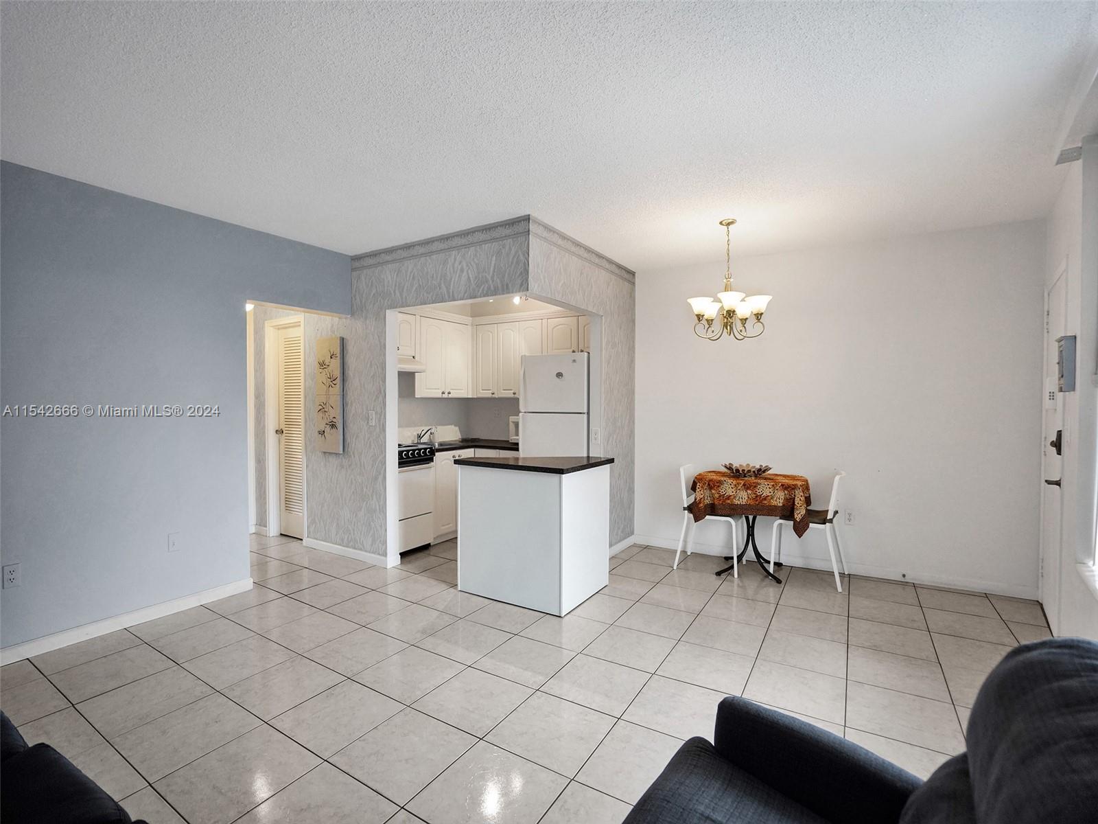 a kitchen with stainless steel appliances a refrigerator and a stove top oven