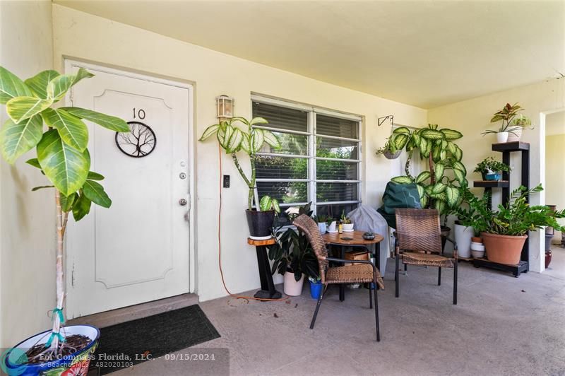 a view of a workspace with furniture and a potted plant