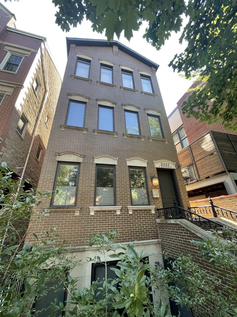 a view of a brick building next to a yard