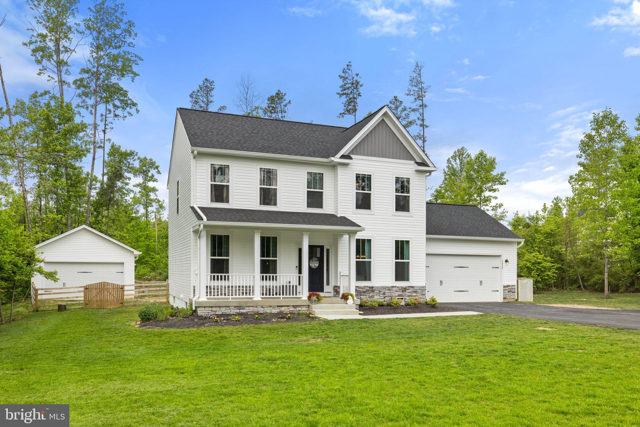 a front view of a house with a garden and yard