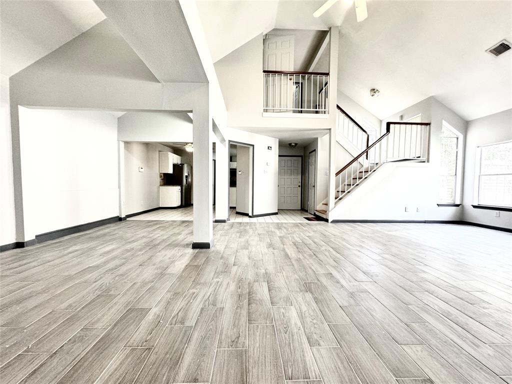 a view of empty room with wooden floor