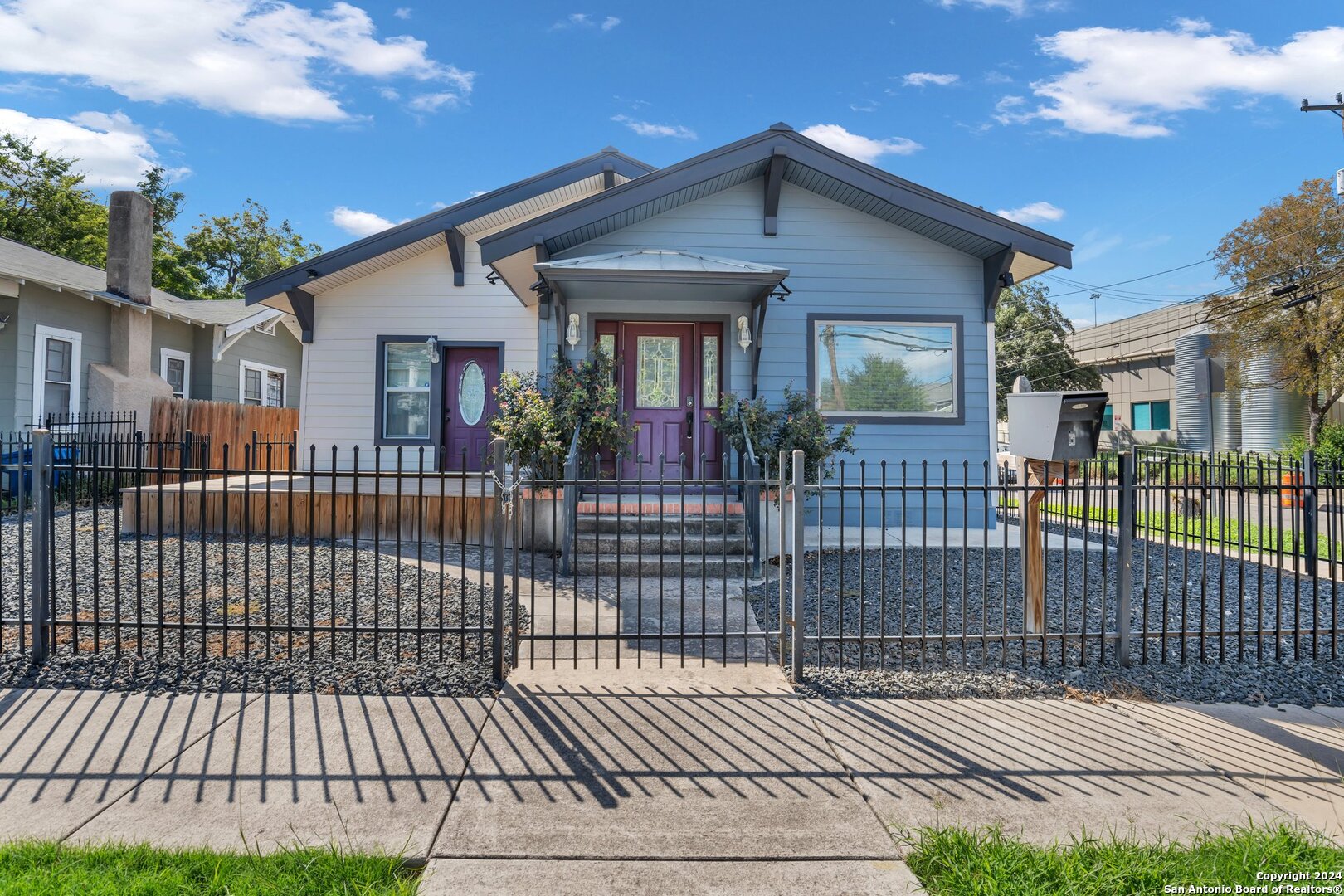 a view of a house with a wooden fence