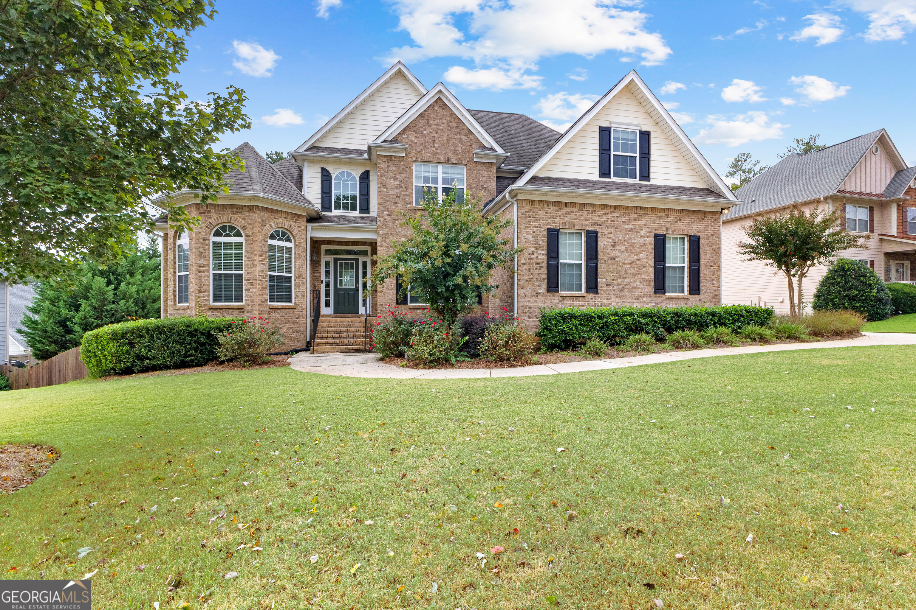 a front view of a house with a yard