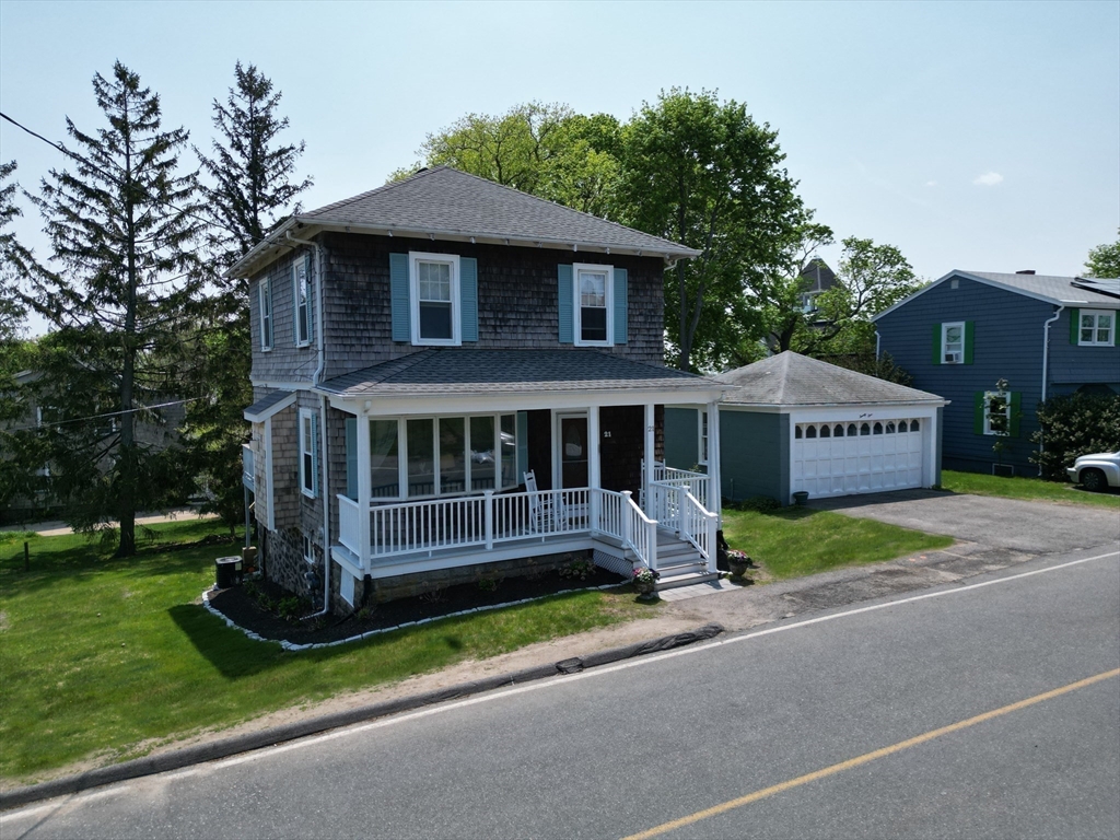 a front view of a house with a garden and deck