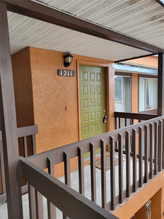 a view of a porch with wooden floor