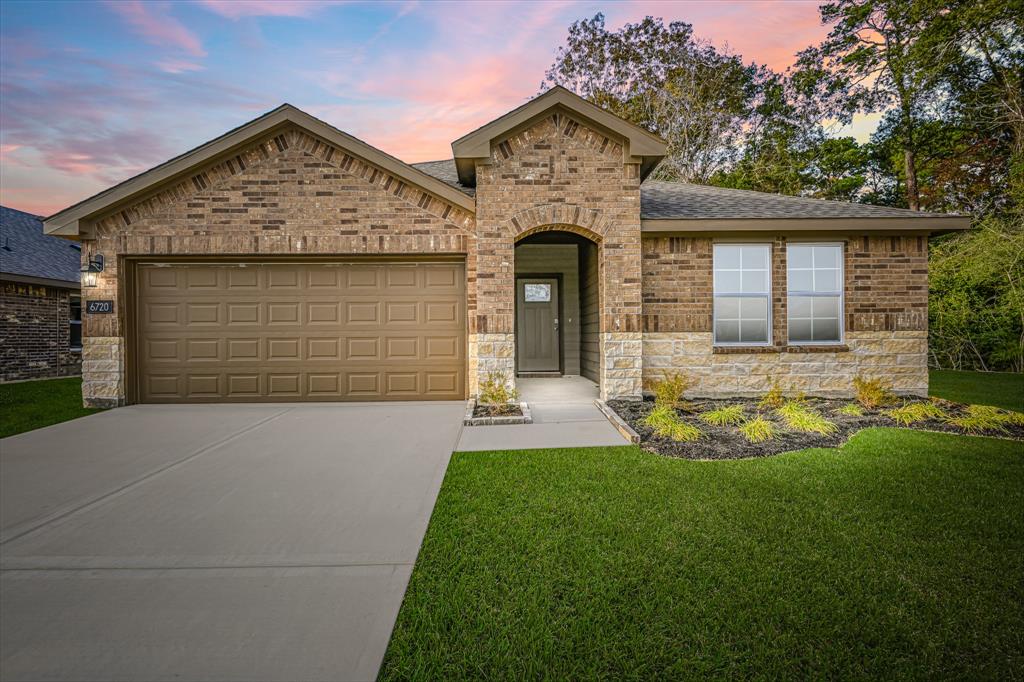 a front view of a house with a yard and garage