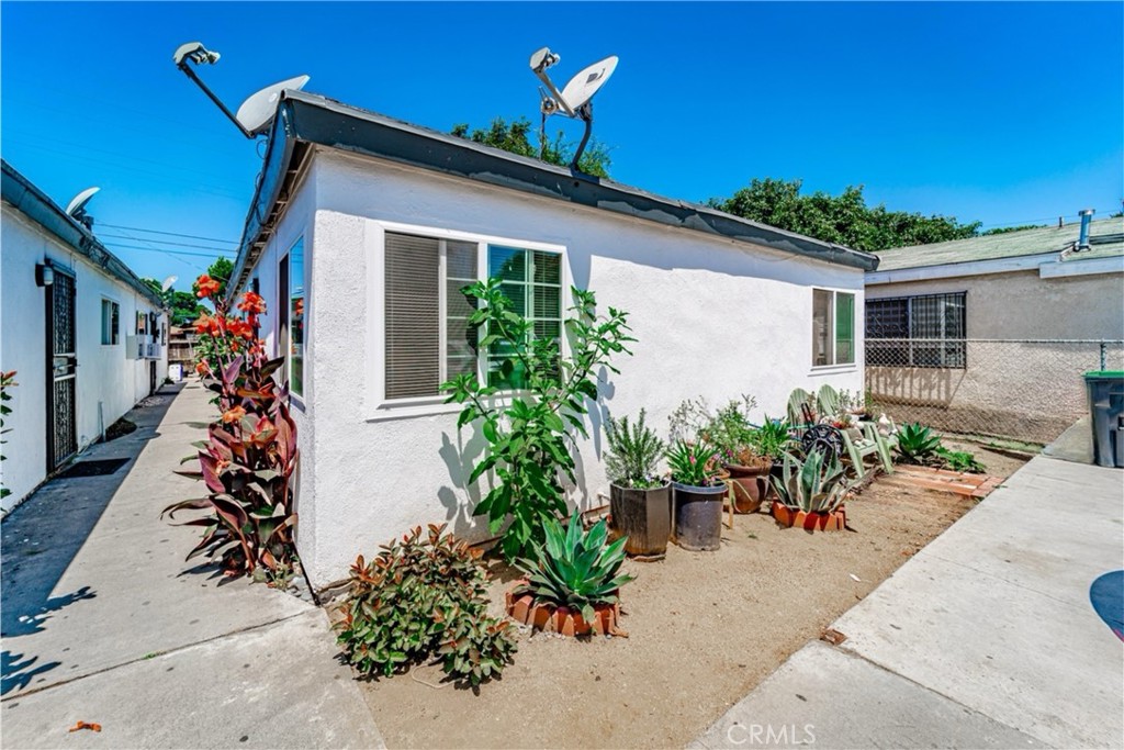 front view of a house with potted plants