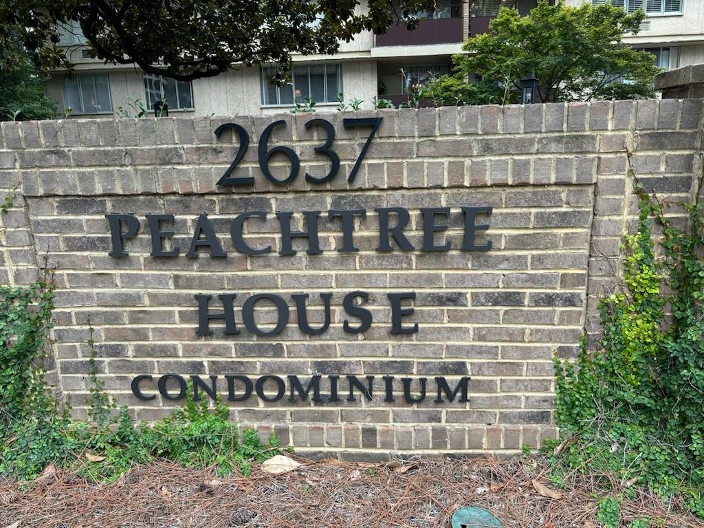 a front view of a building with glass windows and a yard