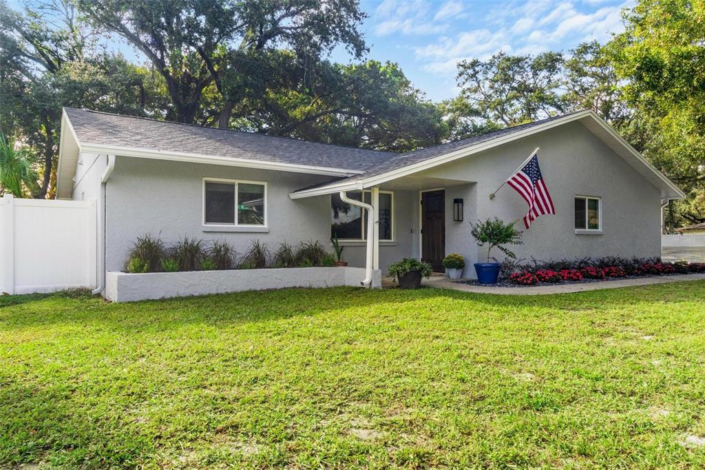 a view of a house with pool and a yard