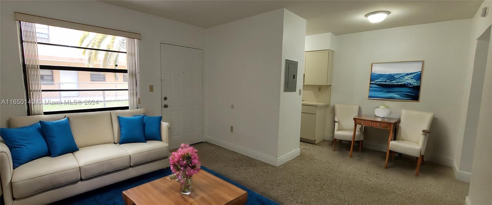 a living room with furniture and a window