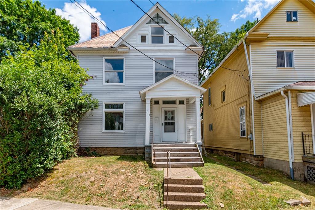 a front view of a house with a yard