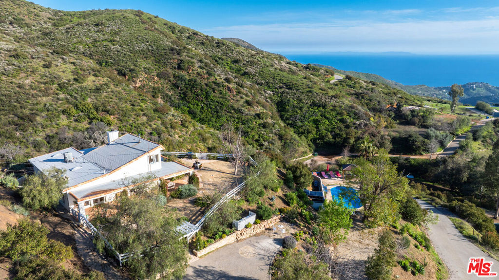 an aerial view of a house with a yard