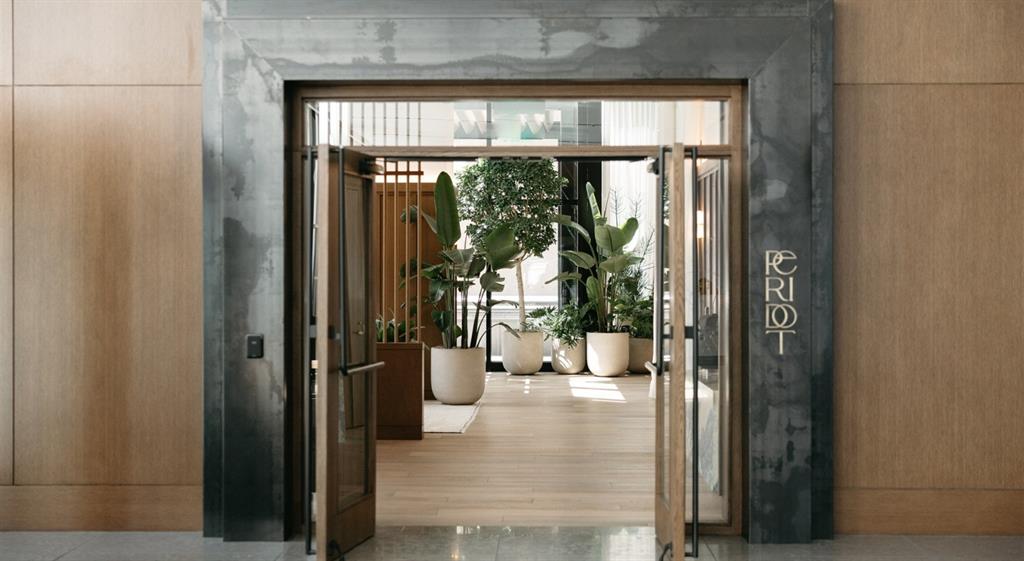 a view of a hallway with wooden floor and a living room