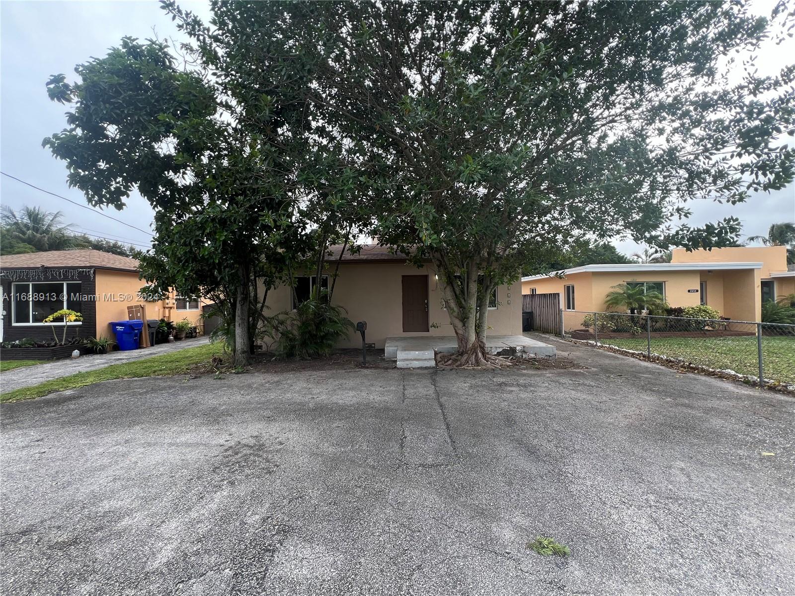 a view of a house with a yard and garage