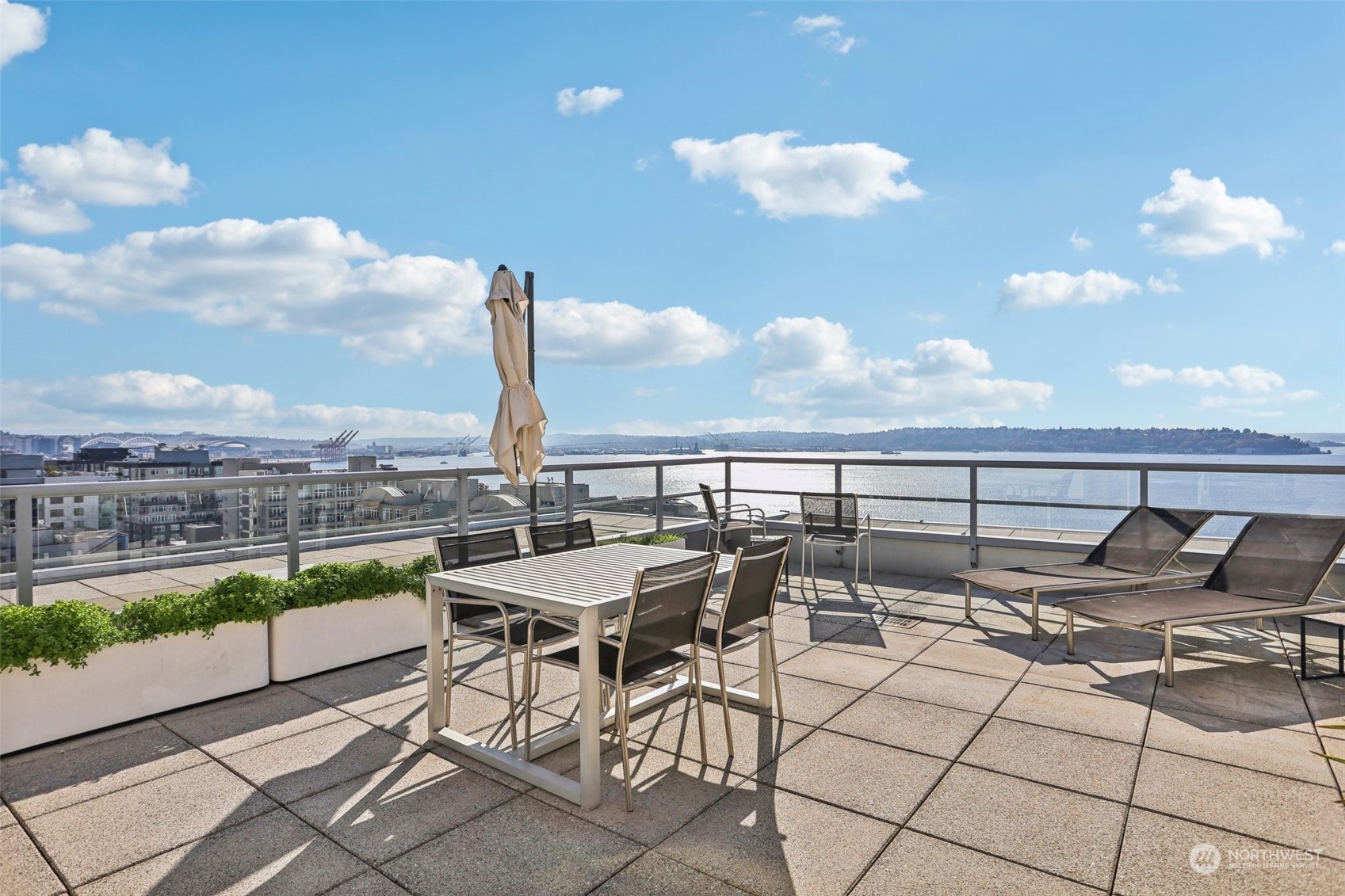 a view of a terrace with furniture and a city view