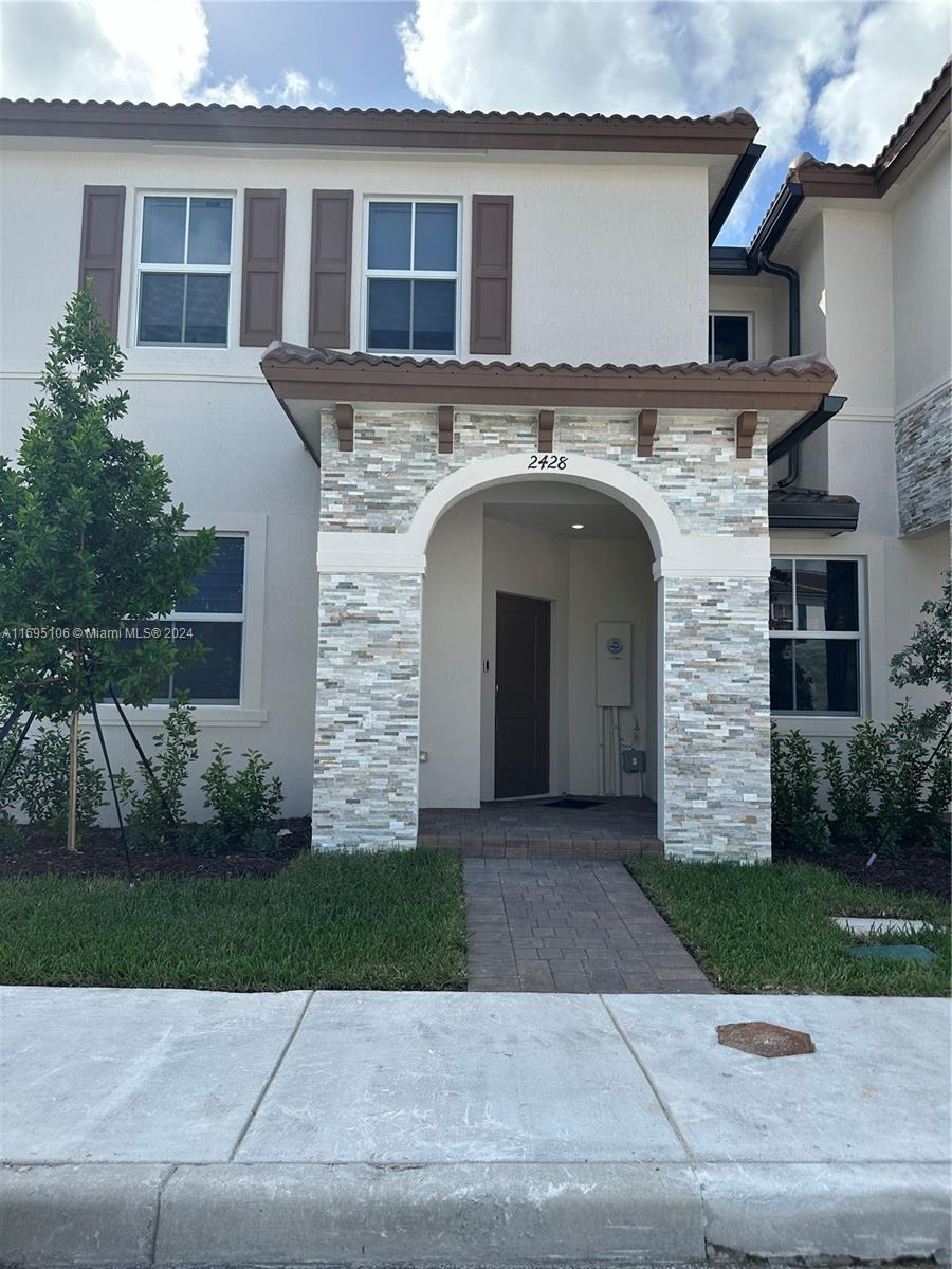 a front view of a house with yard