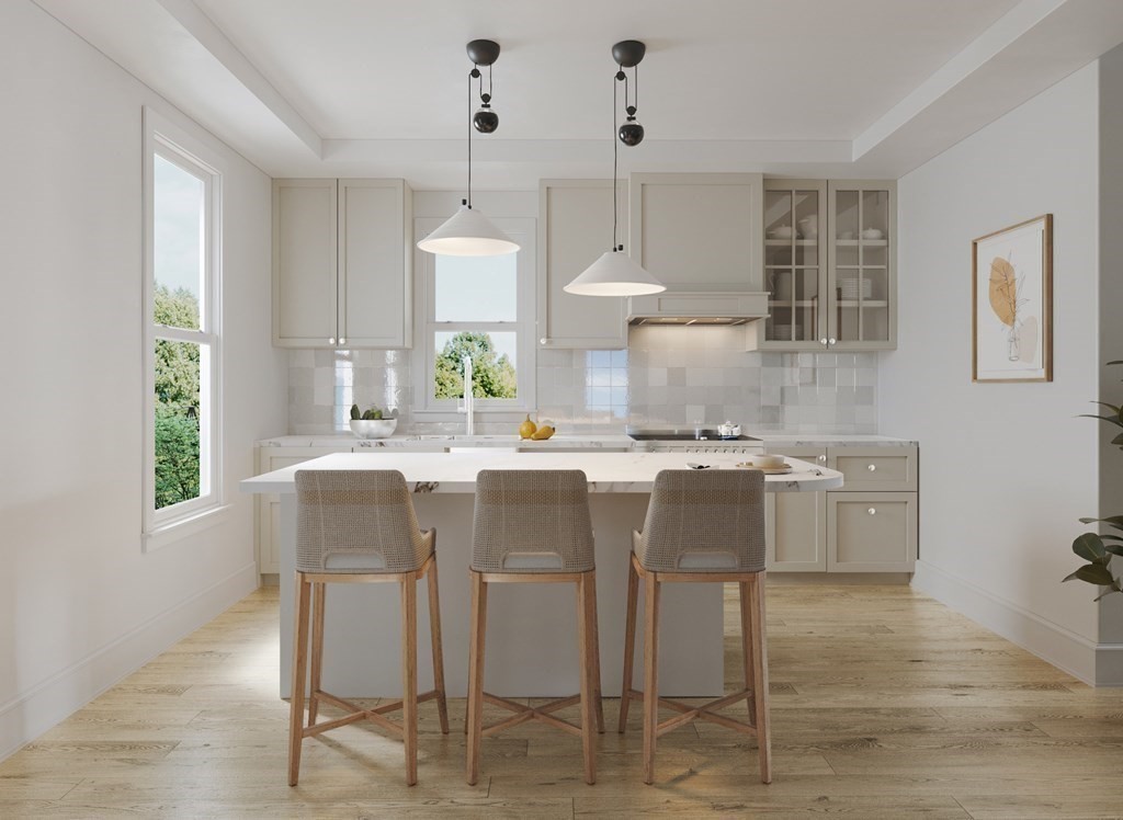 a kitchen with kitchen island granite countertop a sink and a stove