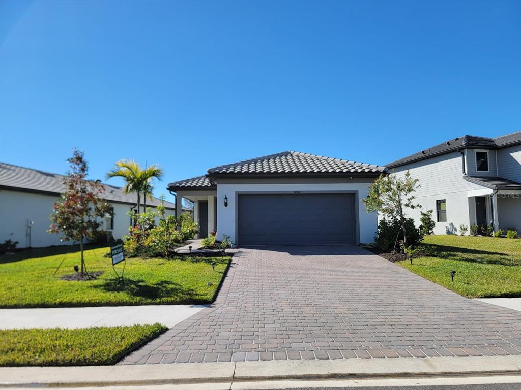 a front view of a house with a yard and garage