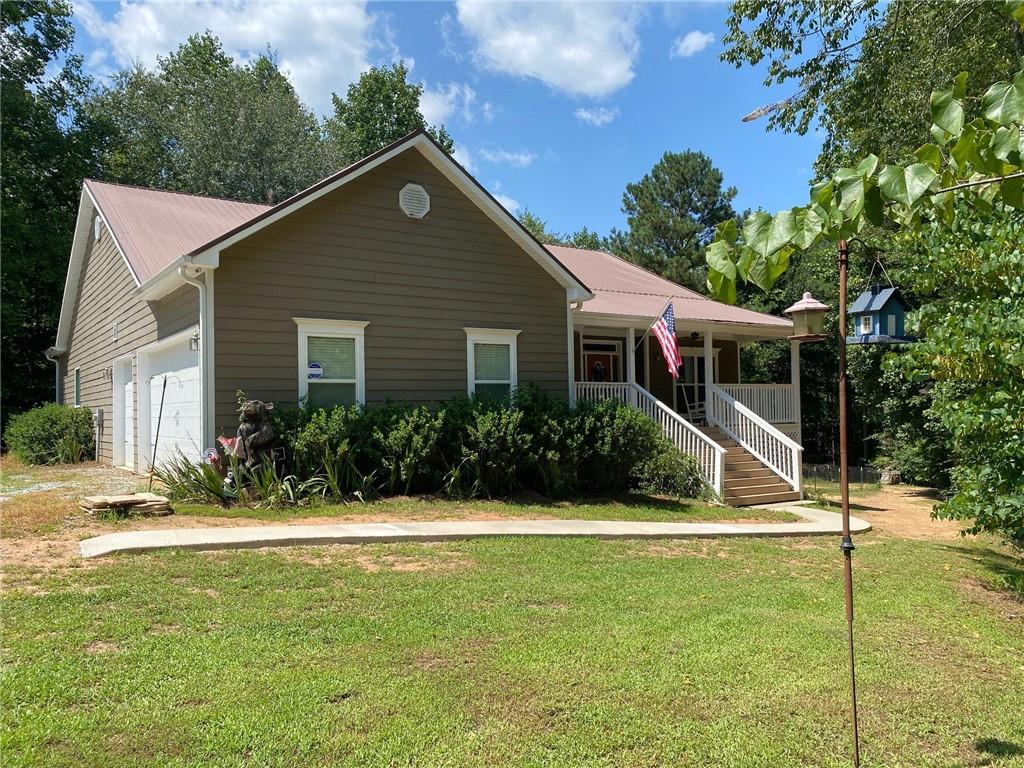 a front view of house with yard and green space