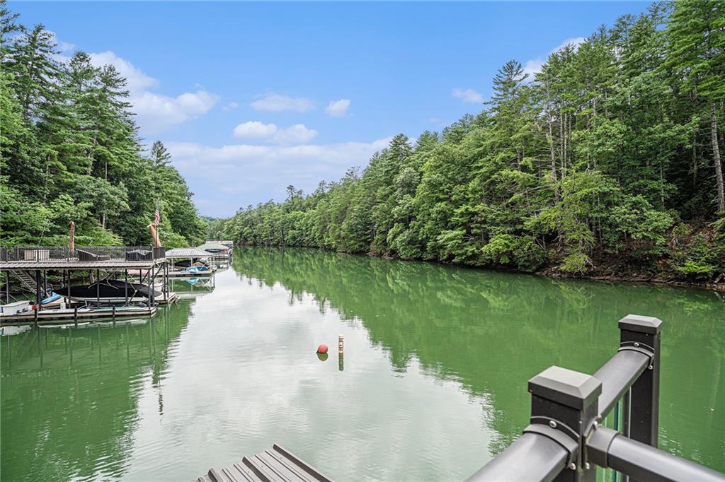 a view of a lake with a table and chairs