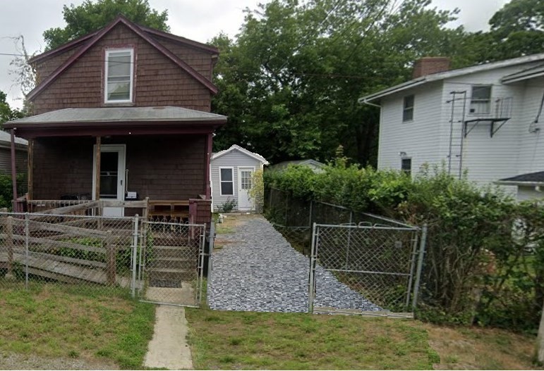 a view of house with swimming pool next to a yard