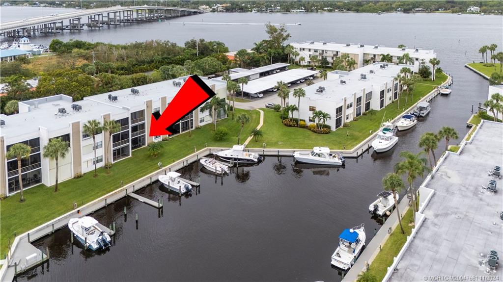 an aerial view of a house with outdoor space and lake view