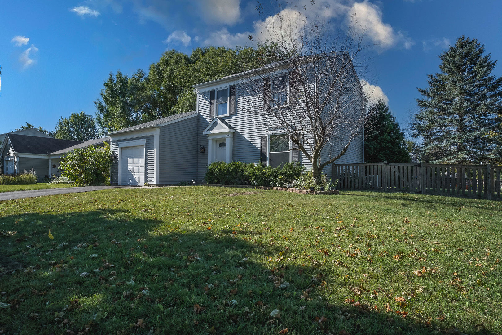 a view of a house with yard and a garden