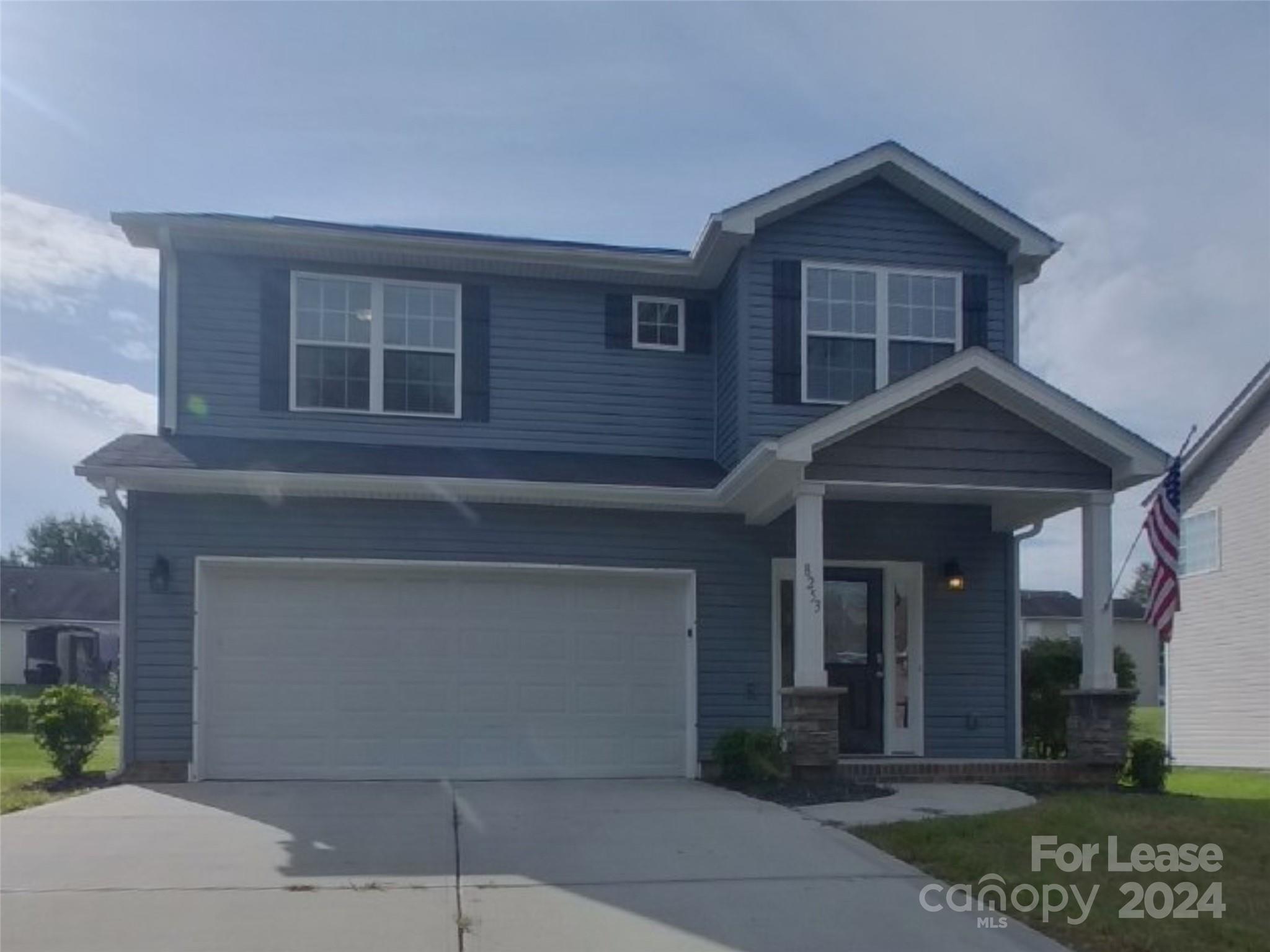 a front view of a house with garage