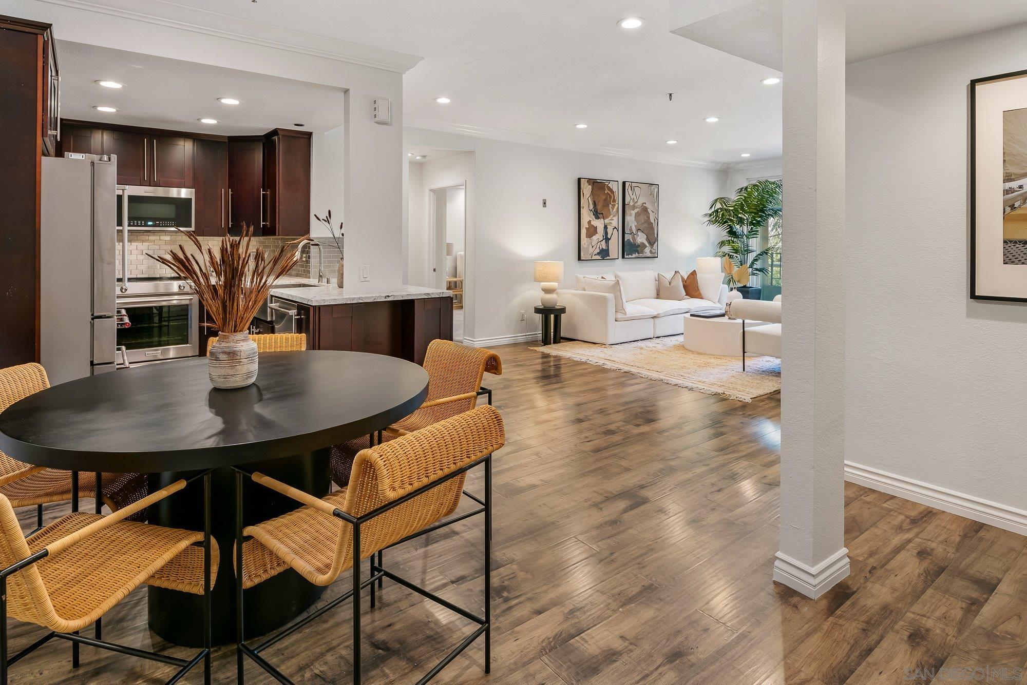 a view of a dining room with furniture and wooden floor