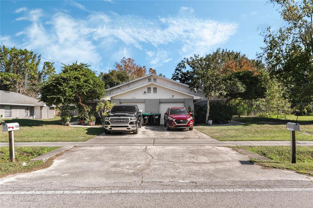 a view of a house with a patio and a yard