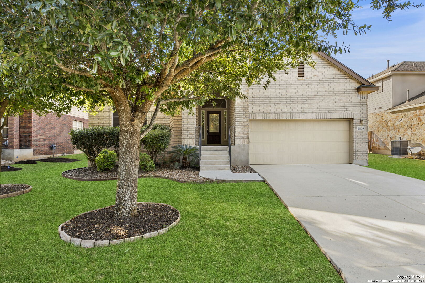 a front view of a house with a yard and garage