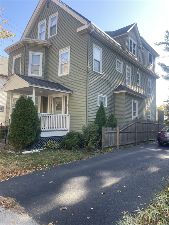 a view of a brick house with a yard