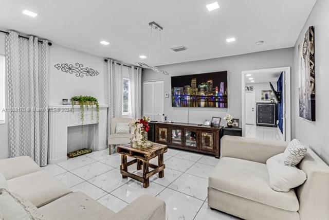 a living room with furniture and a flat screen tv