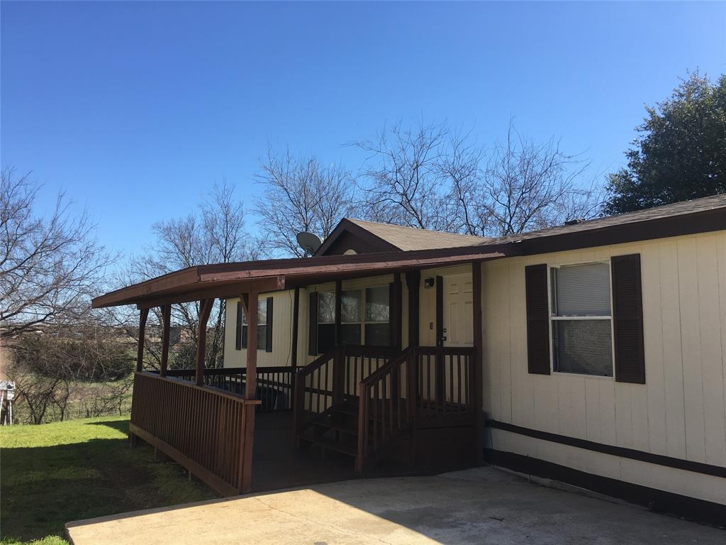 a view of a wooden deck and a backyard